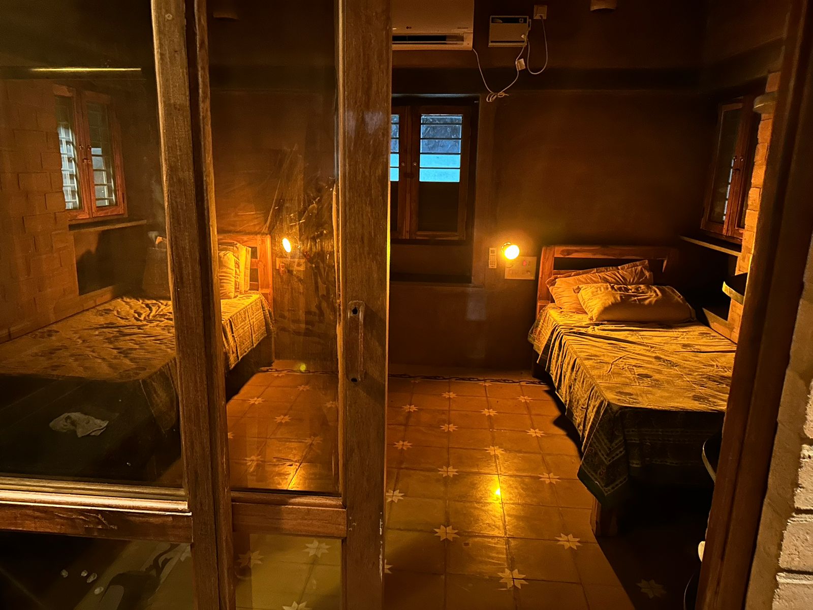 Warmly lit guest room with terracotta tiled floor