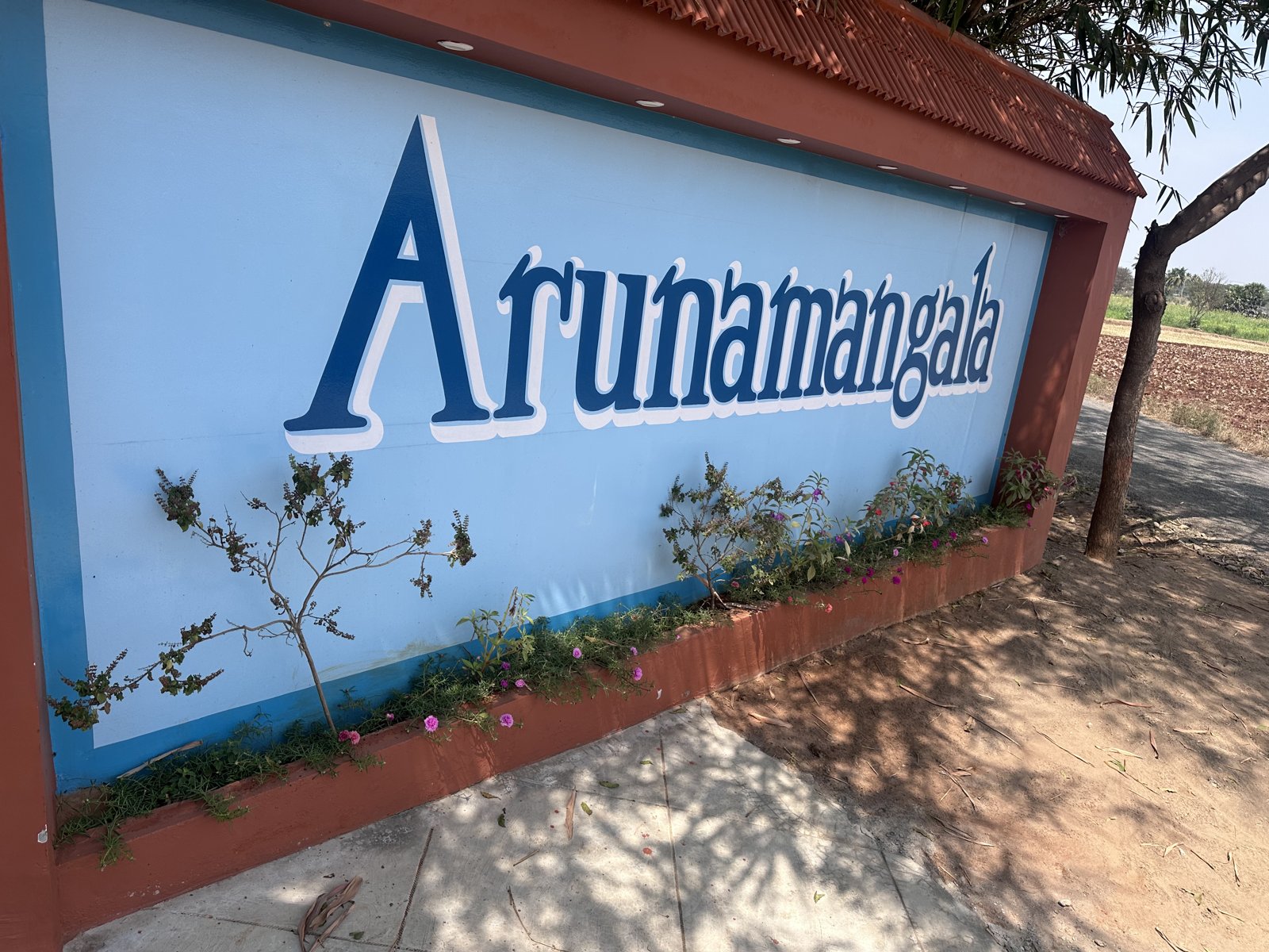 Painted entrance wall reading Arunamangala