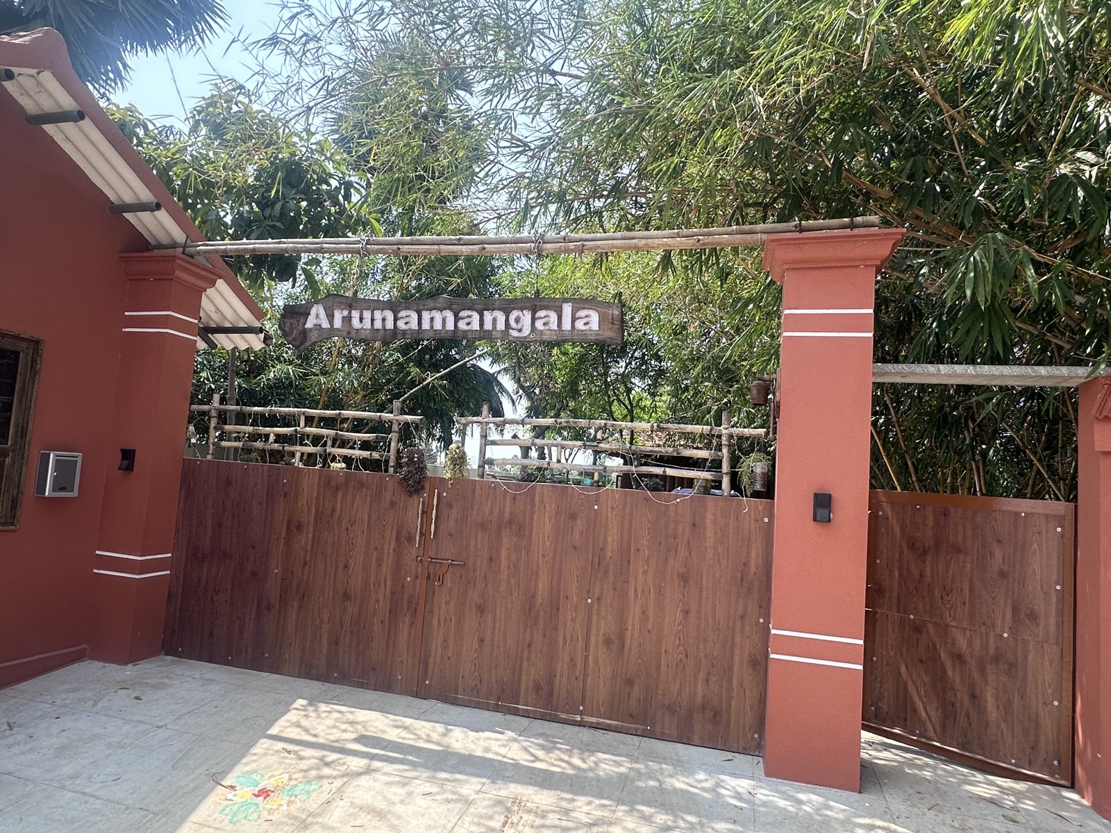 Wooden gate with hanging Arunamangala nameboard