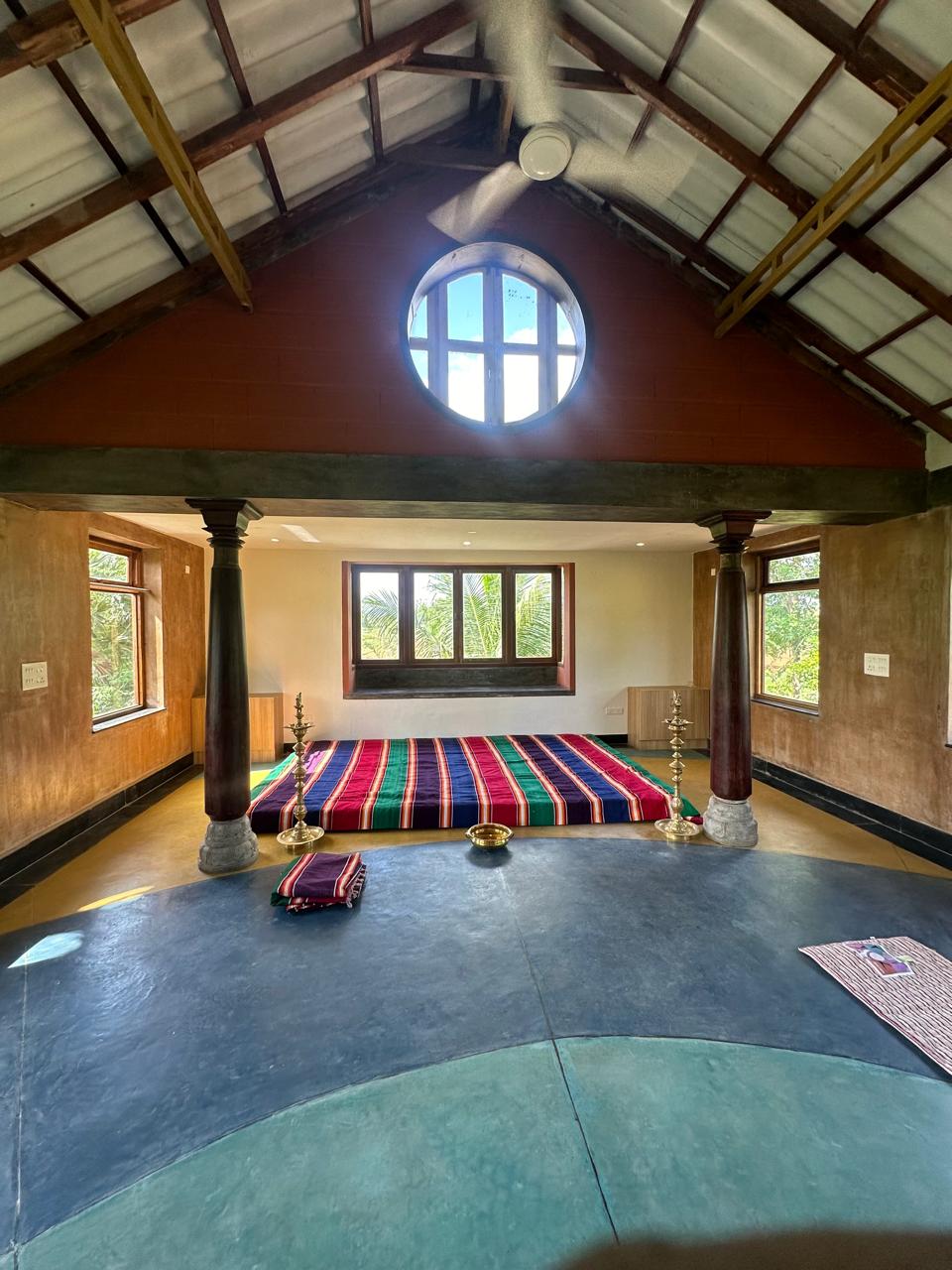 Dhyana Nilaya meditation hall with floral motifs and mountain view